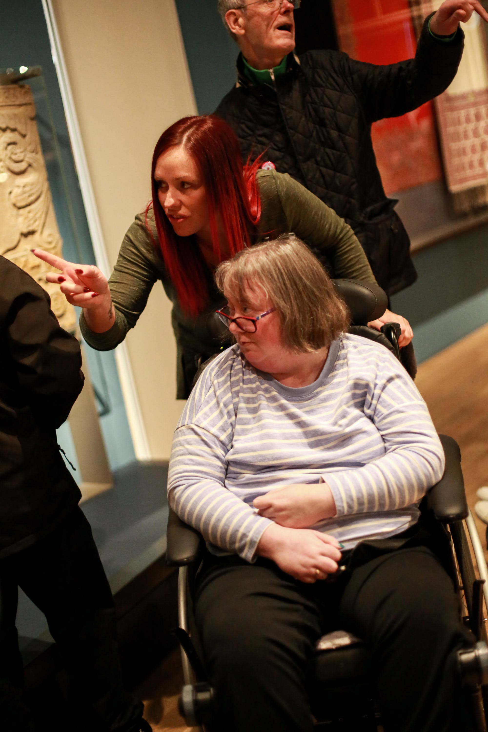 A woman who uses a wheelchair looking at objects in Scottish Design Galleries